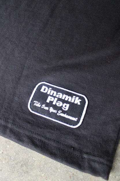 Dinamik Tee Black/Purple with white embroidered patch near hem.